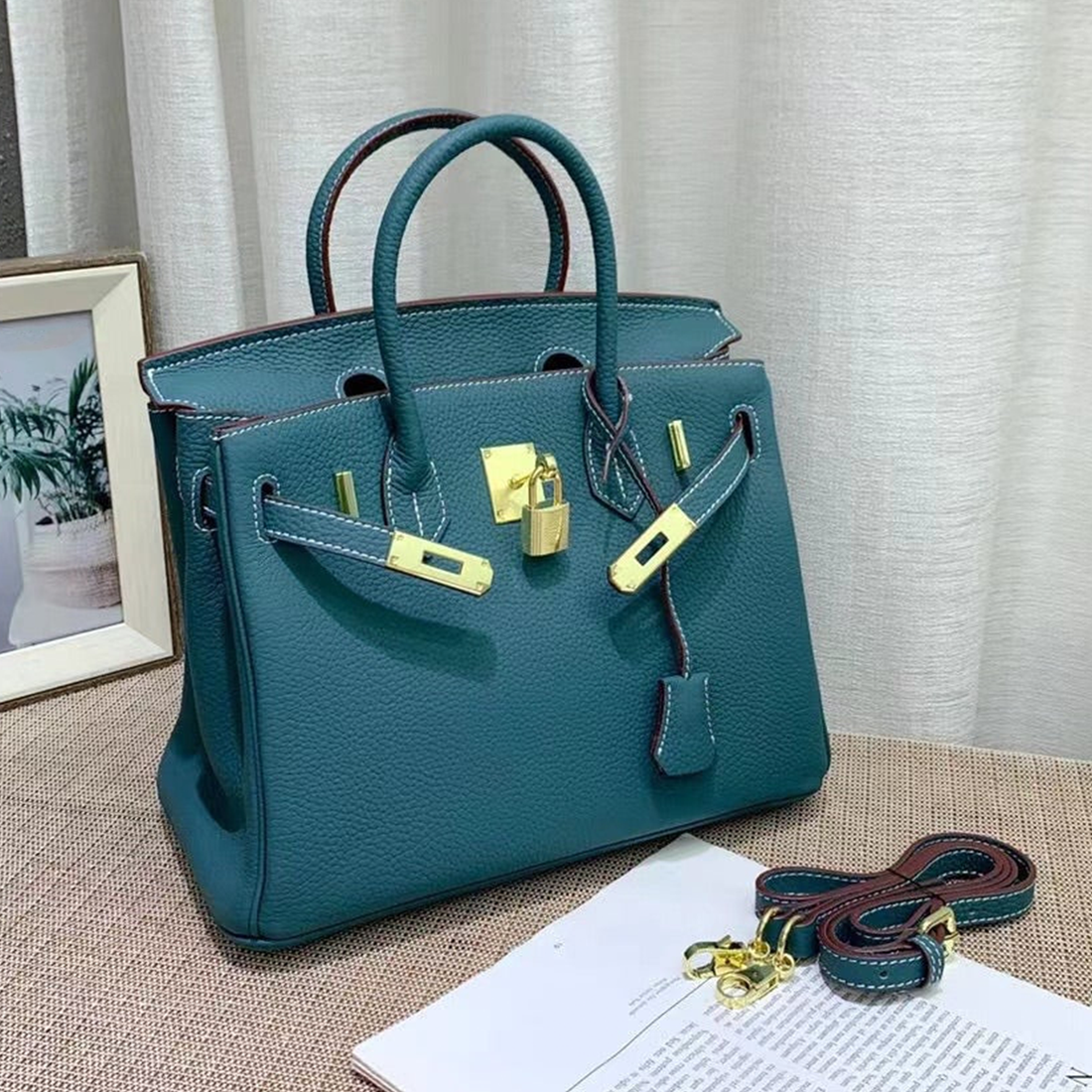 Soothing Malachite Teal Soft Pebbled Grain Compact Reversible Structured Hand Tote With Contrast Pale Edge Stitching, Polished Golden Twist Lock Hardware And Matching Suspended Textured Tag Solid Metal Padlock Charm